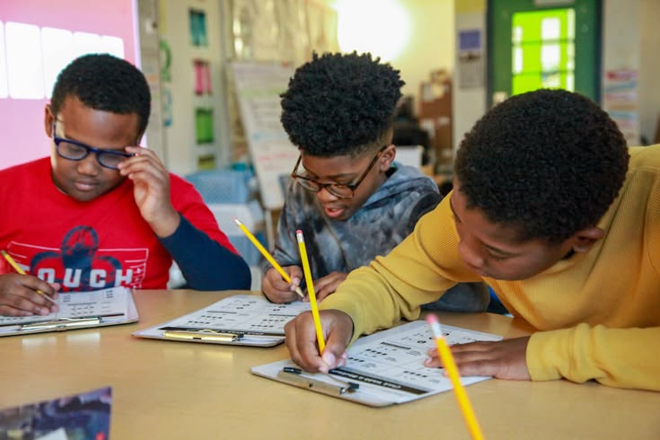 African students studying together with books in a bright classroom